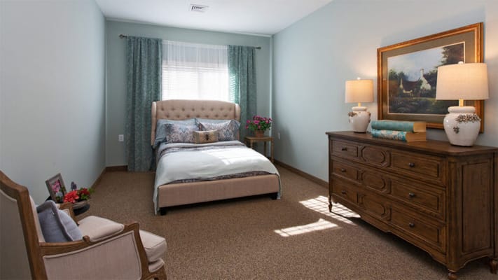 Cozy, well-lit resident room with comfortable furnishings