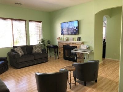 Bright interior common area with seating and a TV
