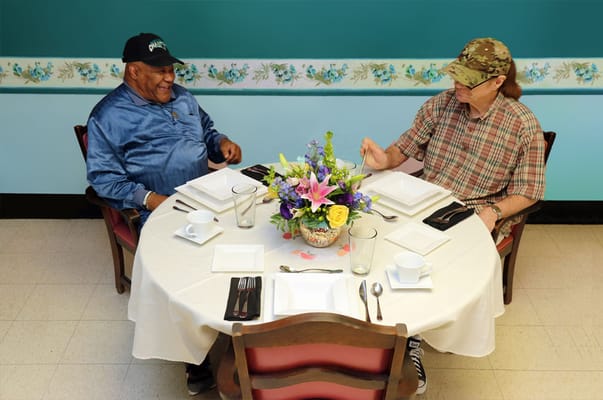 Two residents enjoying a meal together at a dining table