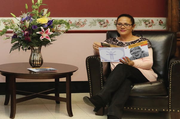 A woman reading in a cozy sitting area