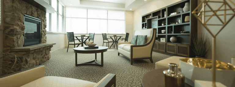 Cozy interior common area with seating and a fireplace