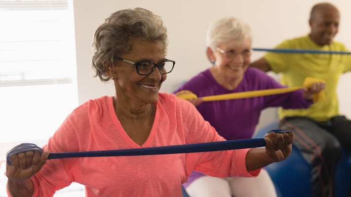 Seniors participating in a group exercise class indoors