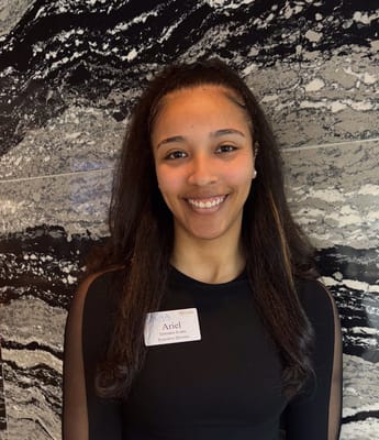 A staff member smiling in an interior setting