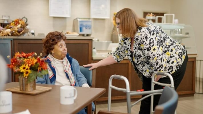 A staff member interacting with a resident in a common area