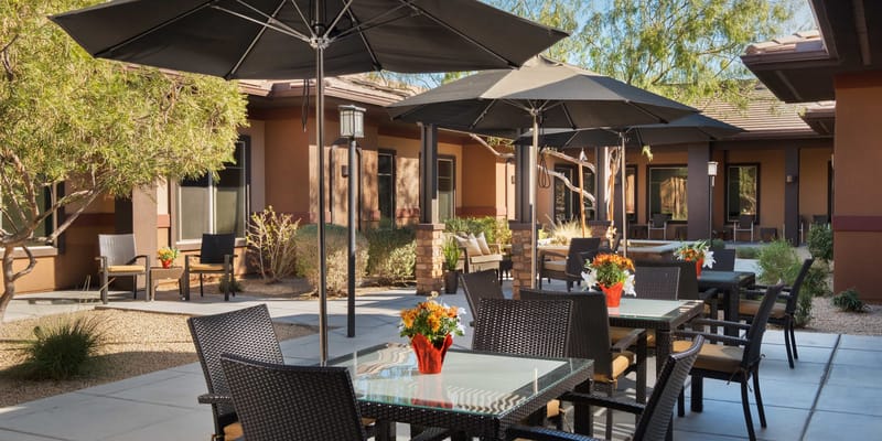 Outdoor patio area with tables and chairs