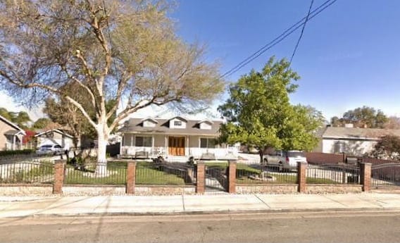 Exterior view of a senior living facility with a garden