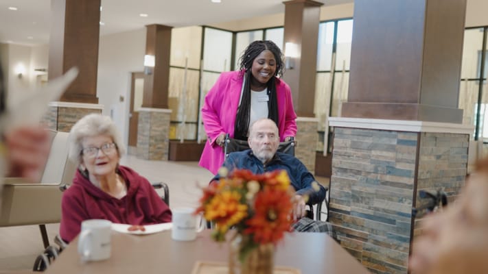 Residents interacting with staff in a common area