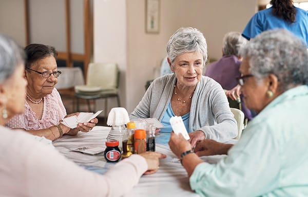 Residents engaging in a card game in a common area