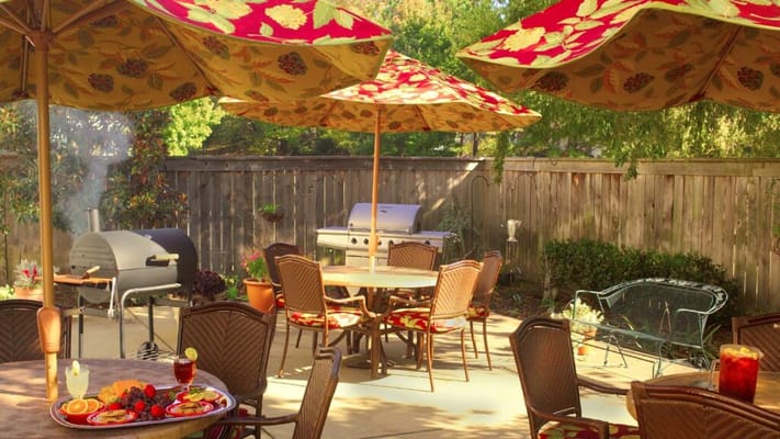 Outdoor patio with dining tables and grill
