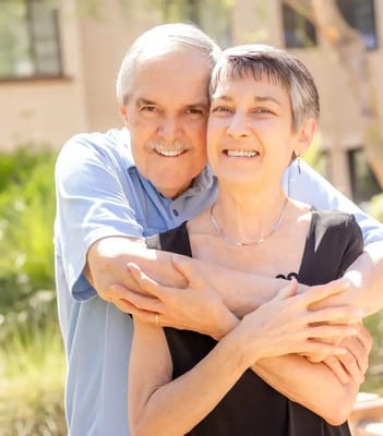 Couple smiling in a garden setting