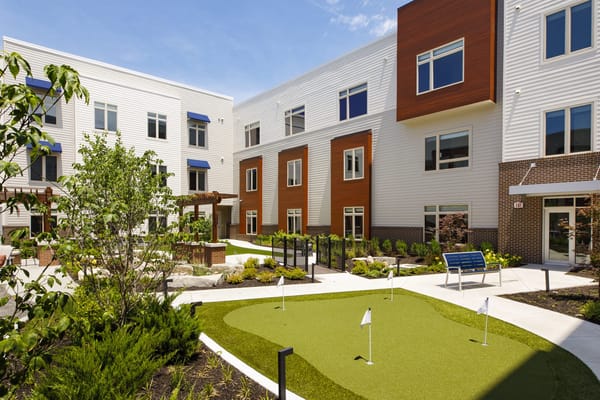 Outdoor area with putting green and landscaped garden