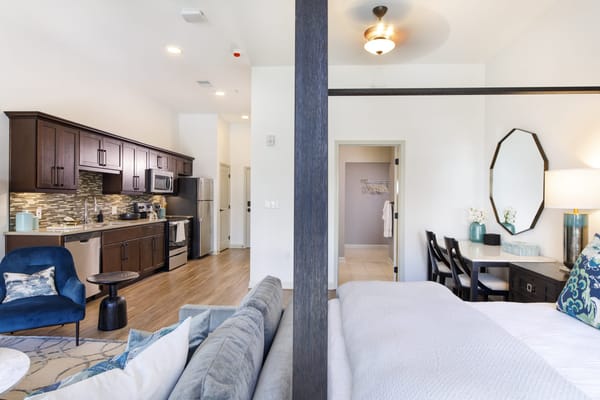 Well-furnished resident room with kitchenette and living area