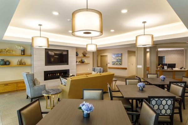 Bright common area with seating and a fireplace