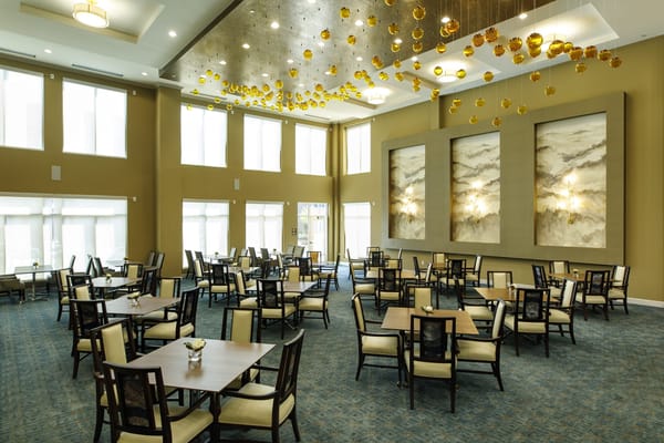 Dining area with tables and chairs in a well-lit room