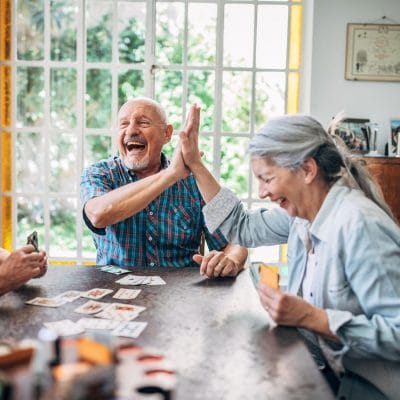 Residents enjoying a card game and laughing together