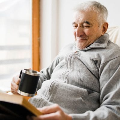 Resident enjoying a book in a cozy area