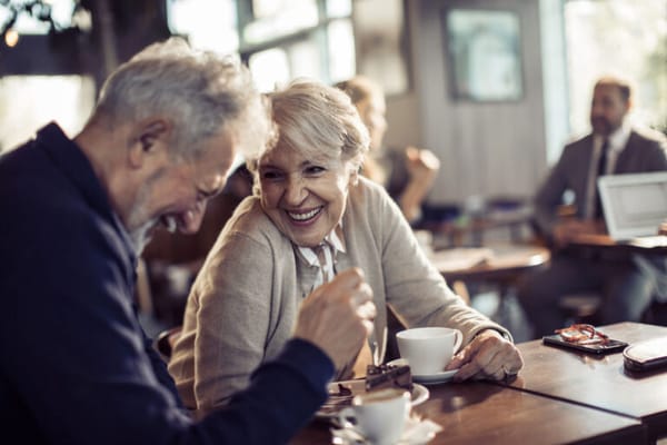 Couple enjoying coffee and conversation in a common area