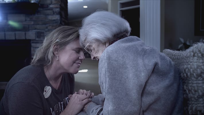 Staff member interacting with a resident in a cozy interior