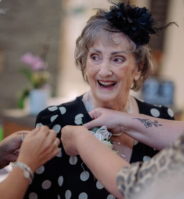 Celebration with a joyful resident receiving a flower