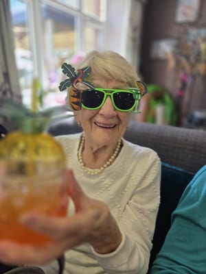 Resident enjoying a colorful drink at a community event