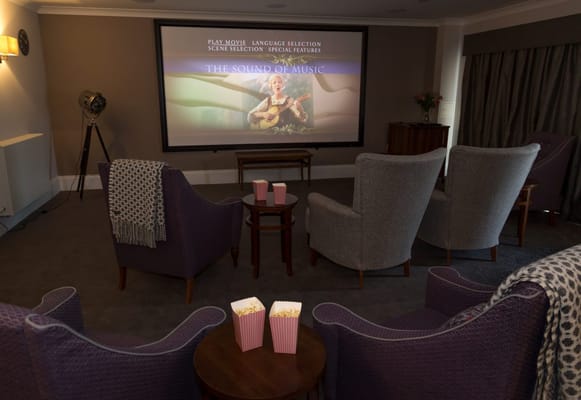 Cozy activity room with popcorn and movie screen