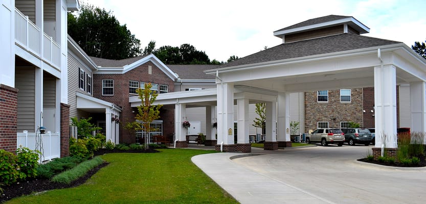 Entrance of a senior living facility with landscaped grounds