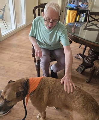 Resident interacting with a dog in a common area