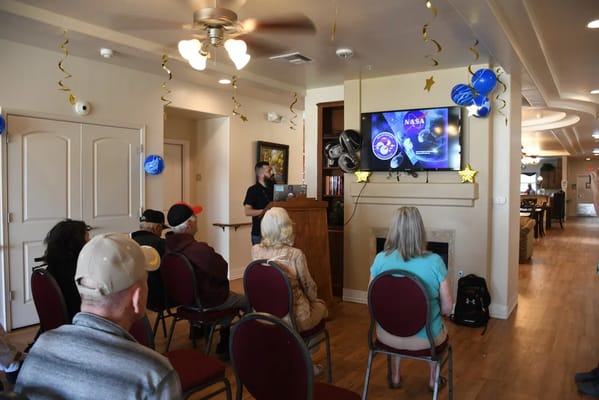 Residents attending a presentation in a common area
