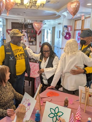 Residents and staff engage in an arts and crafts activity