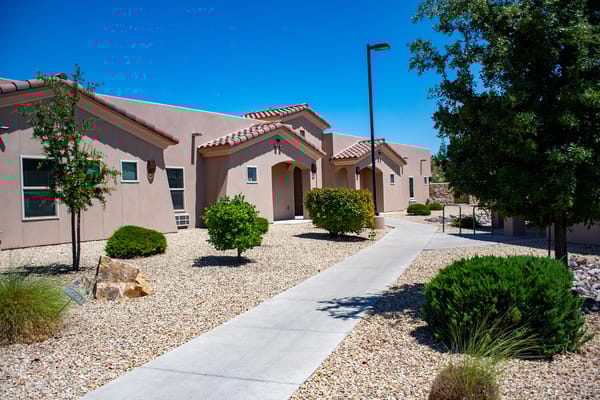 Pathway leading to a residential building with landscaping