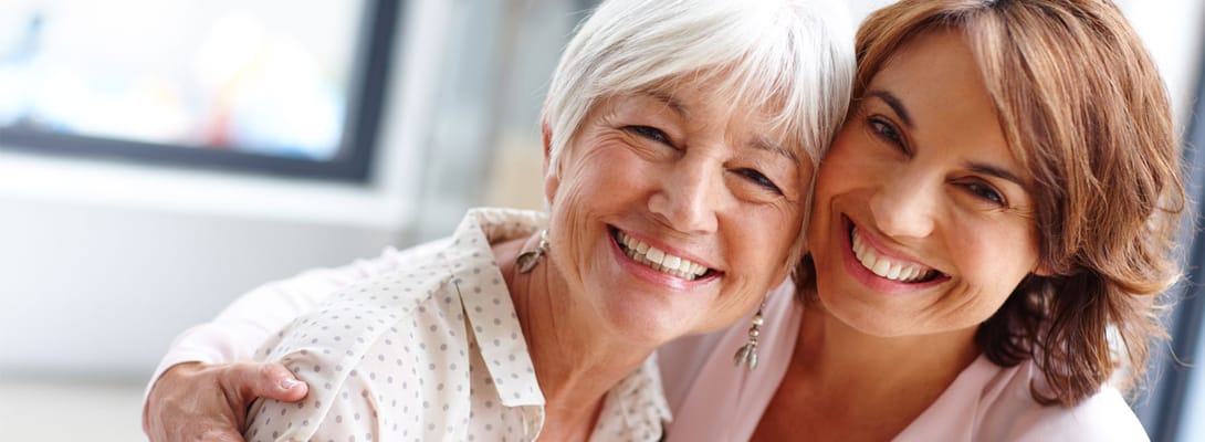 Two smiling women enjoying a moment together