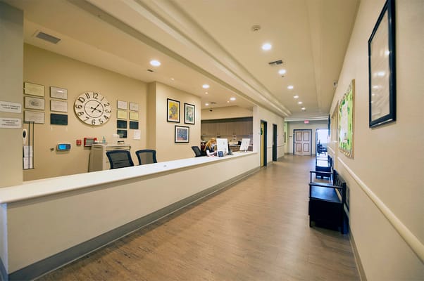 Bright reception area with a desk and seating