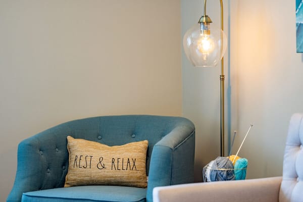Cozy seating area with a 'Rest & Relax' pillow
