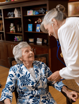 Staff member interacting with a resident in a cozy common area
