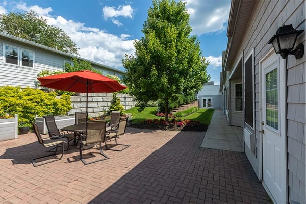 Outdoor patio area with seating and landscaping