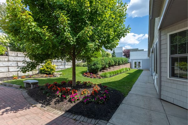 Well-maintained garden area with flowers and trees