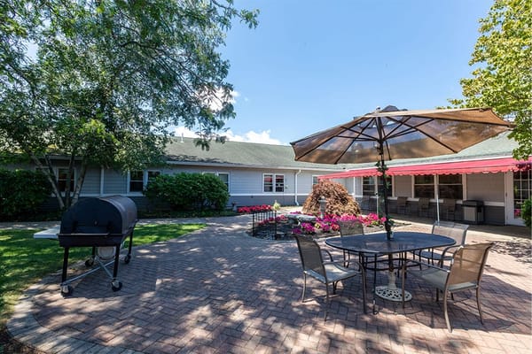 Outdoor patio area with seating and grill