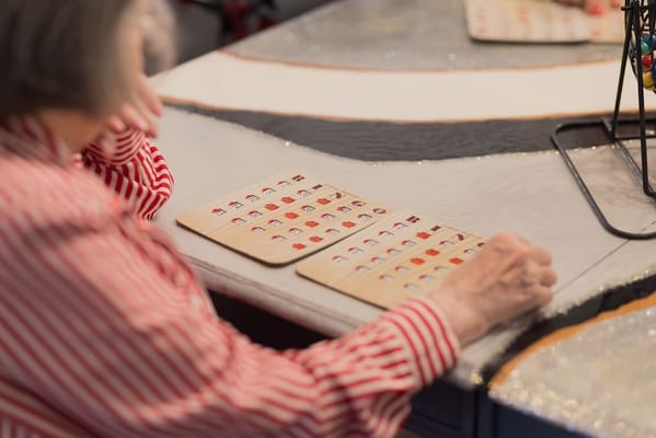 A resident playing bingo at a game table