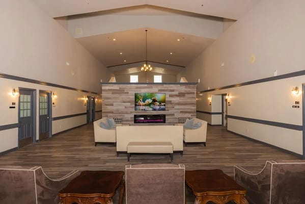 Spacious common area with seating and TV