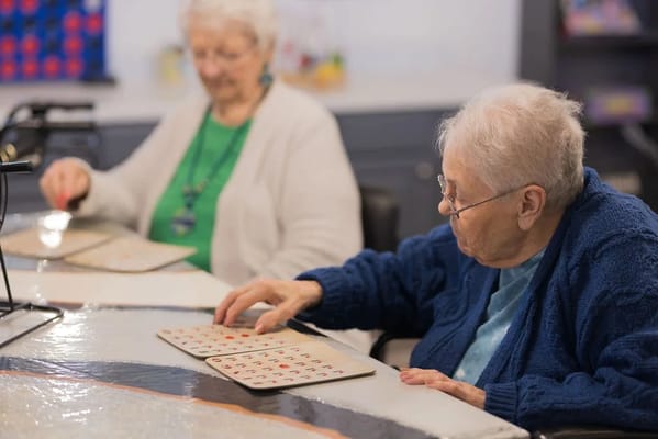 Residents playing bingo in an activity room