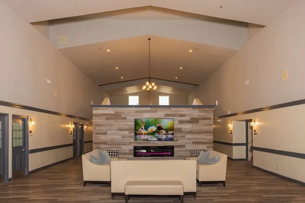 Bright lobby area with seating and entertainment center