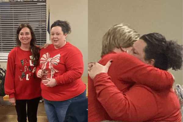 Staff members celebrating with awards in an indoor setting