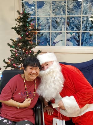 Resident enjoying a visit from Santa during holiday festivities