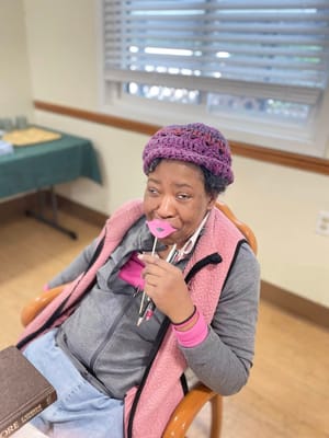 Resident enjoying a playful moment with a prop