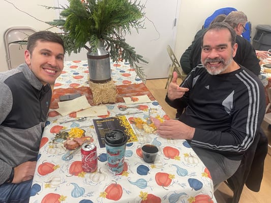 Two residents enjoying a meal at a festive table
