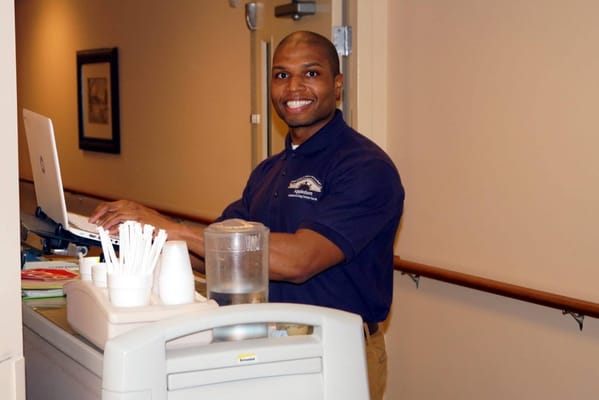 Staff member at reception desk with a computer