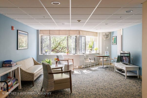 Bright common area with seating and large windows