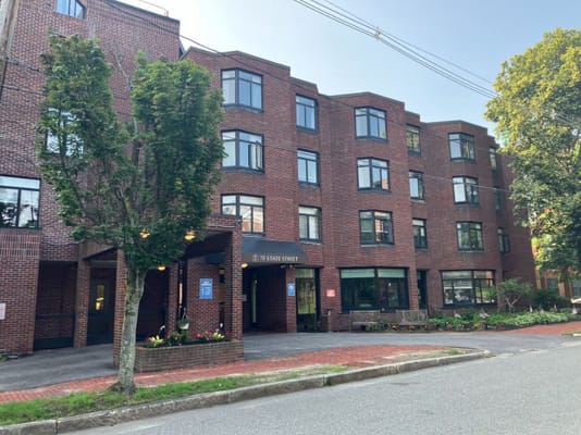 Exterior view of a senior living facility with landscaped entry