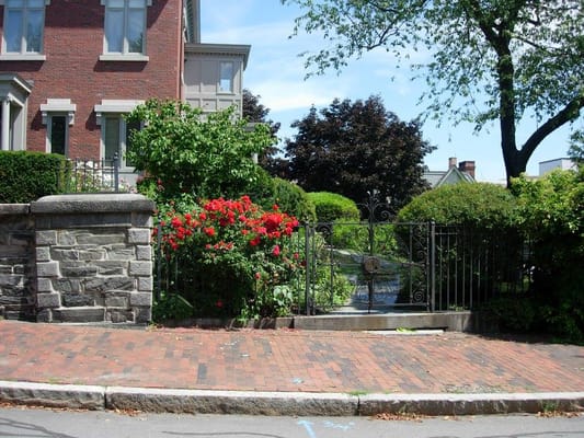A lush garden and entrance gate of a nursing home