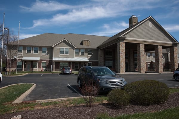 Exterior view of Forest Hills Commons facility with parking